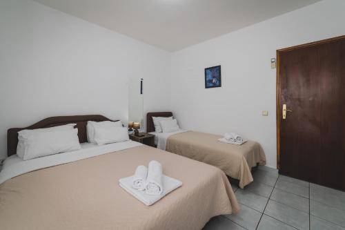 a bedroom with two beds with towels on them at Apartments Memidz in Budva