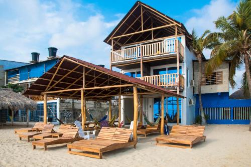 a group of chairs and a building on the beach at Mamallena Beachside Rincon del Mar in Rincón
