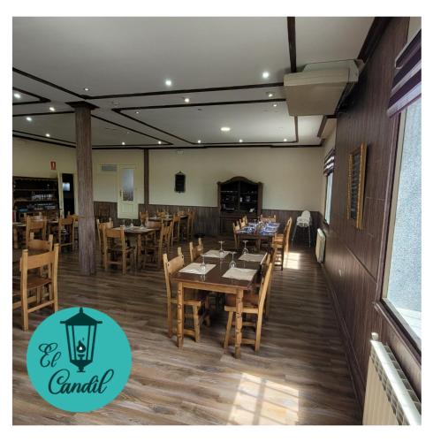 a dining room with wooden tables and chairs at EL CANDIL in Villacastín
