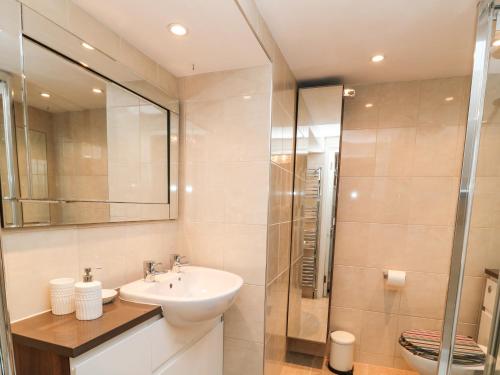 un baño con lavabo y ducha en Old Town House, en Dawlish