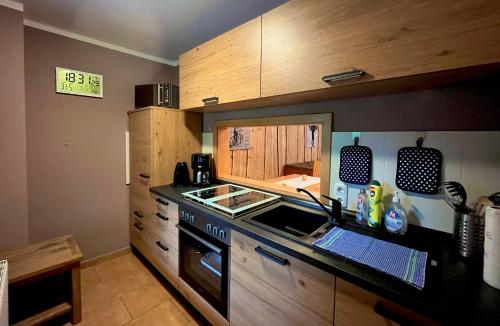 a kitchen with a sink and a stove top oven at Ferienwohnung-direkt-am-Skihang mit Sauna in Kurort Oberwiesenthal