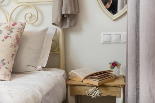 a bedroom with a bed with a book on a table at Naxos Petite Studios in Agios Prokopios