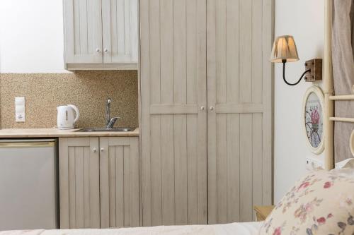 a bedroom with a sink and a cupboard at Naxos Petite Studios in Agios Prokopios