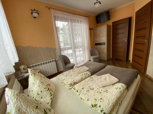 Posteľ alebo postele v izbe v ubytovaní DARIA pokoje gościnne