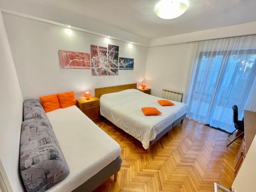 a bedroom with two beds and a couch in it at Apartments Villa Mattossi in Rovinj