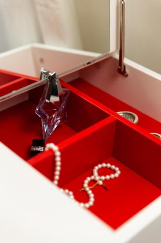 a red bathroom sink with a chain in it at Apartment Sancti Viti in Rijeka