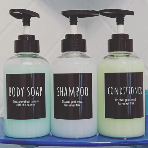 three bottles of soap on a blue shelf at Barzio Paradise in Barzio