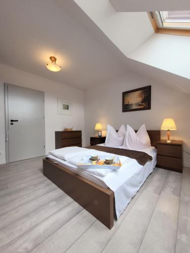 a bedroom with a large bed and two night stands at IWONA Pokoje Apartamenty in Karwia