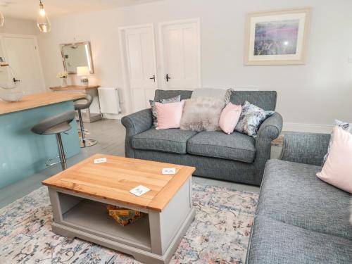 a living room with two couches and a coffee table at Fox View Cottage in Hexham