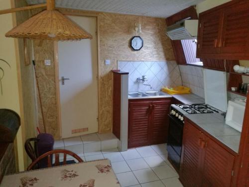 a kitchen with a sink and a stove at Szőnyi úti vendégház in Zebegény