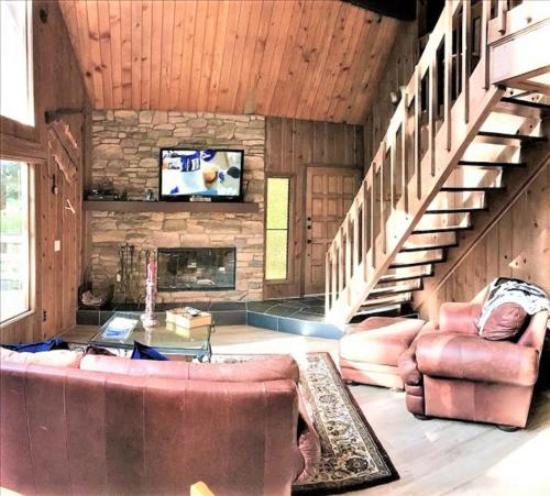 a living room with a couch and a fireplace at Klamath - V057 Cabin in Lake Arrowhead