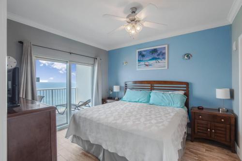 a bedroom with a bed and a balcony with the ocean at Crystal Tower 1906 by Vacation Homes Collection in Gulf Shores