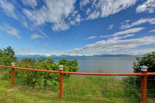 a fence with a view of a body of water at The Lighthouse in Homer
