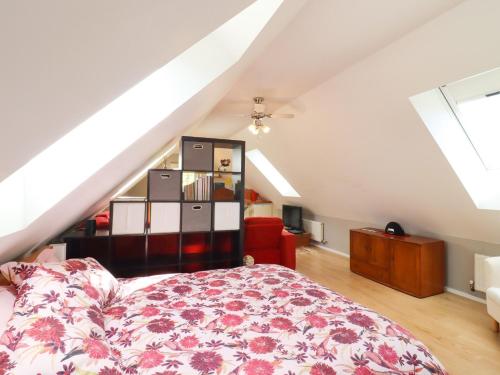 a bedroom with a bed and a book shelf at The Studio in Astwick