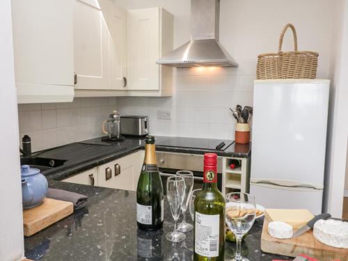 two bottles of wine sitting on a counter in a kitchen at Merlin in Kingsbridge