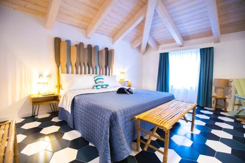 a bedroom with a bed with a blue comforter at Suitetti Camere&Relax in San Nicola Arcella