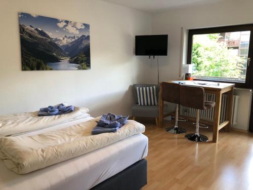 a room with two beds and a desk with a computer at Apartment Colonia in Garmisch-Partenkirchen