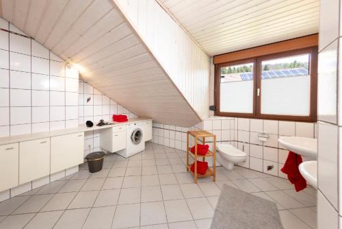 an attic bathroom with a toilet and a sink at Ferienwohnung im Alpenblick in Steinen