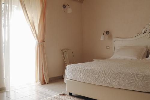 Cama ou camas em um quarto em Masseria Petrusella