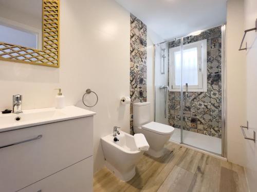 a bathroom with a toilet and a sink and a shower at El Rincón de Fabio Little Apartments in Cádiz