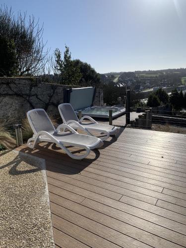 a group of chairs sitting on a wooden deck at Studio de Charme "Le Coquillage " Jacuzzi privatif in Pléneuf-Val-André