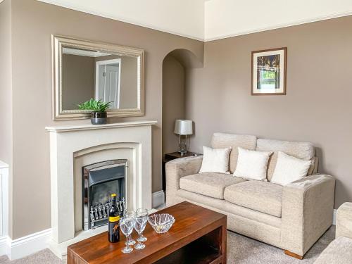a living room with a couch and a fireplace at Cedar House - Quaint Victorian Home With Free Parking in York