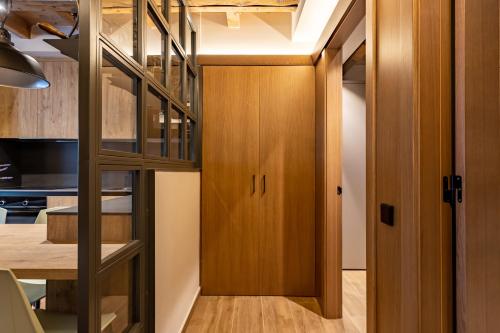 a room with a staircase leading to a kitchen with a dining table at Cerdanya Mountain Residences in Bellver de Cerdanya 