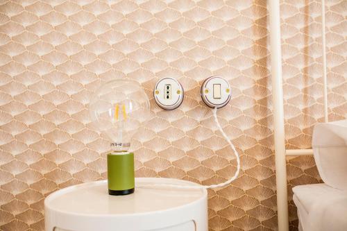 a bathroom with a toilet with two clocks on the wall at Suitetti Camere&Relax in San Nicola Arcella