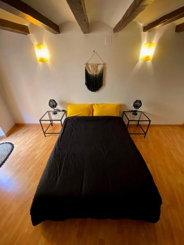 a bedroom with a large bed and two lamps at Cornu Karma Apartment El Pati in Cornudella