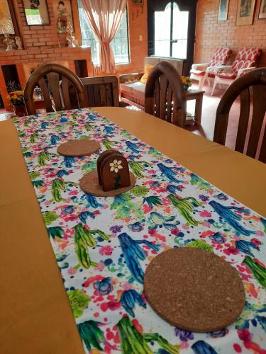 a table with a table cloth with a hat on it at La Cabaña de Tano in Mineral del Monte