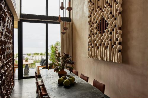 a dining room with a table with fruit on it at Etéreo, Auberge Collection in Playa del Carmen