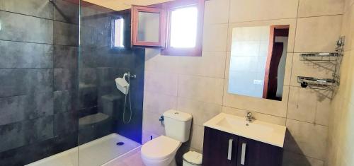 een badkamer met een toilet, een wastafel en een douche bij Conil, 5min centro, playas in Conil de la Frontera