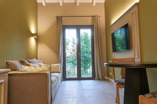 a living room with a couch and a sliding glass door at Alle Siepi in Reggio Emilia