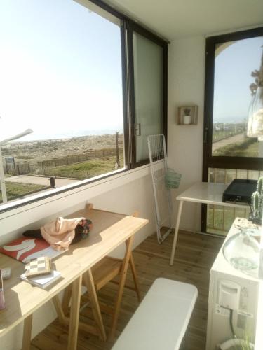 a room with a table and a view of the ocean at T3 avec magnifique vue mer in Le Barcarès