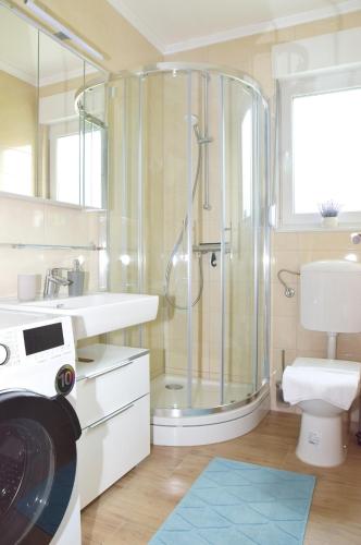 a bathroom with a shower and a toilet and a sink at Apartman RIO in Jajce