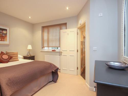 a bedroom with a bed and a window at Flat 1, 32 Newcomen Road in Dartmouth