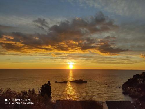 a sunset over the ocean with the sun setting at Apartment Ulcinj in Ulcinj