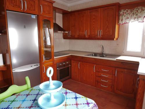 a kitchen with wooden cabinets and a table with a bowl on it at Mary's Home in Moya