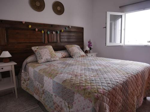 a bedroom with a large bed and a window at Mary's Home in Moya