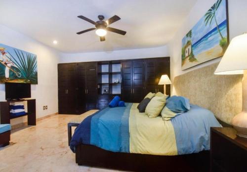 a bedroom with a bed with a ceiling fan at Corto Maltes 105 in Playa del Carmen