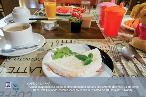 a table with a plate of food and a cup of coffee at i9 Quixaba Flat in Itacaré