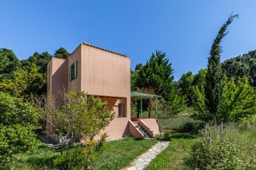 a house on a hill with trees at Myrto's House at Agnontas in Agnontas