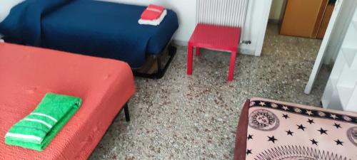 a living room with a red couch and a red chair at Appartamento luminoso, semplice con ogni comfort in Lido di Ostia