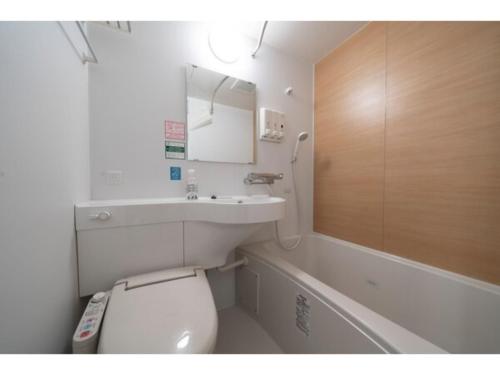a bathroom with a toilet and a sink and a tub at R&B Hotel Sendai Higashiguchi - Vacation STAY 39923v in Sendai