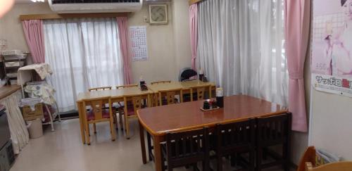 a classroom with a table and chairs in it at INARIRYOKAN - Vacation STAY 47680v in Sayama