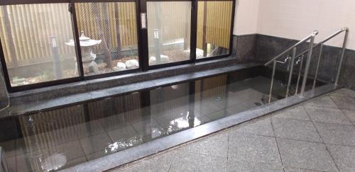 a room with two windows and a floor with glass at INARIRYOKAN - Vacation STAY 47680v in Sayama