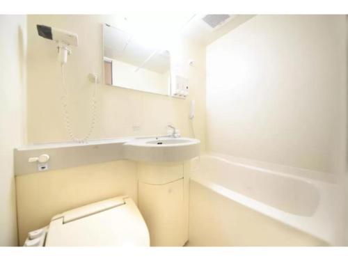 a bathroom with a toilet and a sink and a tub at R&B Hotel Sendai Hirosedori Ekimae - Vacation STAY 39668v in Sendai