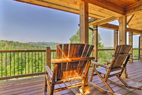 two rocking chairs sitting on a deck with a view at Spacious Mountain Retreat with Hot Tub and Views! in Gatlinburg