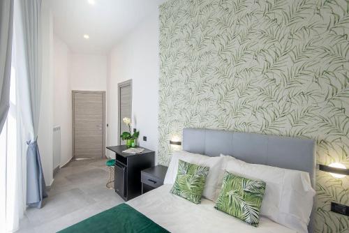 a bedroom with a bed with a green and white wall at Red Queen Naples in Naples