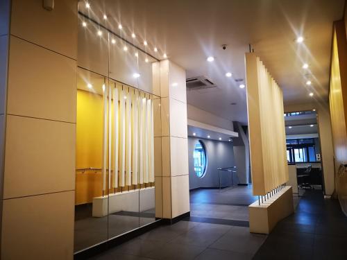 um corredor com colunas e luzes num edifício em 1205OnTheGoldenMile - 4 Sleeper Ocean View with Pool & Braai at 10 South em Durban